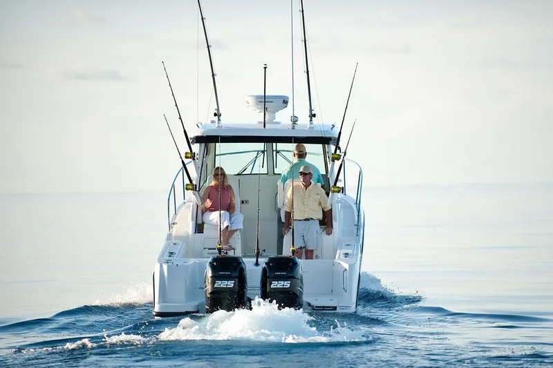 Slide: The Image of Manufacturer Provided Image: 2026 Boston Whaler 285 Conquest cruising on calm waters with three passengers. - 20