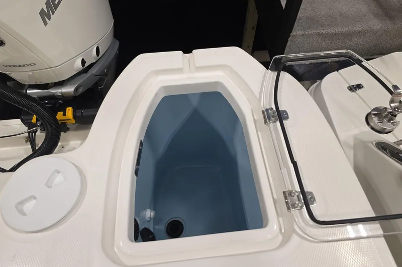 Slide: The Image of 2026 Boston Whaler 285 Conquest boat interior with open storage compartment and engine detail. - 7