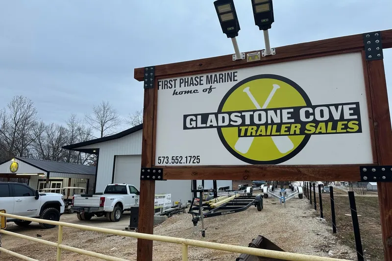 Slide: The Image of Sign for Gladstone Cove Trailer Sales at First Phase Marine, with trucks and trailers visible. - 23