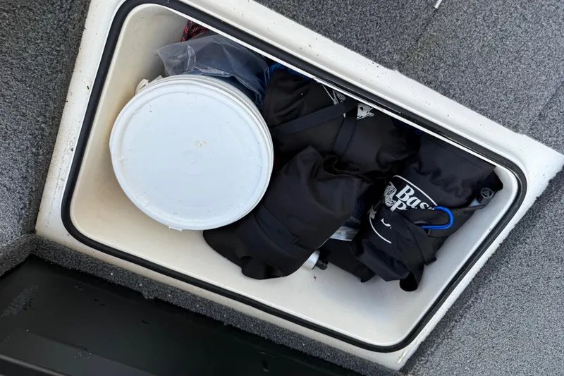 Slide: The Image of Storage compartment in 2020 Vexus AVX 2080 boat, containing fishing gear and a white bucket. - 43