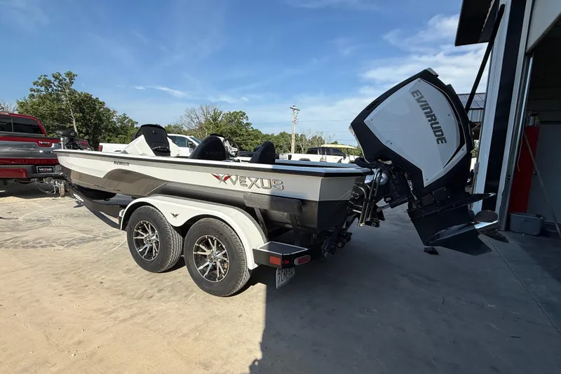 Slide: The Image of 2020 Vexus AVX 2080 boat with Evinrude motor on trailer, parked outdoors. - 5