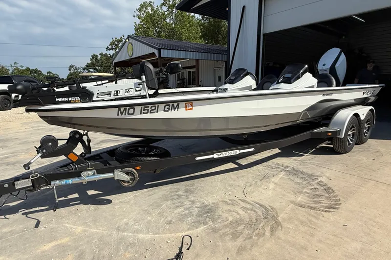 Slide: The Image of 2020 Vexus AVX 2080 boat on trailer, parked outside a garage. - 9
