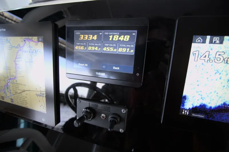 Slide: The Image of Dashboard of a 2001 Pursuit 3070 Center Console with navigation and trip data displays. - 12