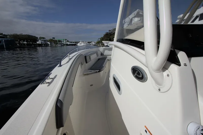 Slide: The Image of 2001 Pursuit 3070 Center Console boat on calm water, showcasing sleek design and spacious deck. - 4