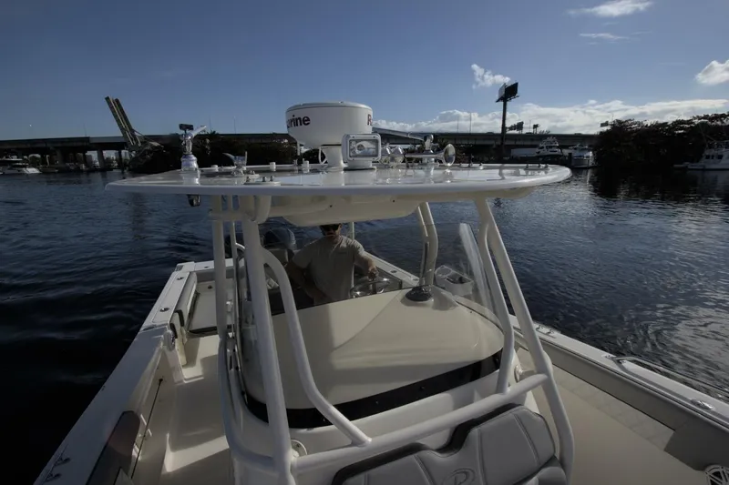 Slide: The Image of 2001 Pursuit 3070 Center Console boat on calm water near a bridge. - 7