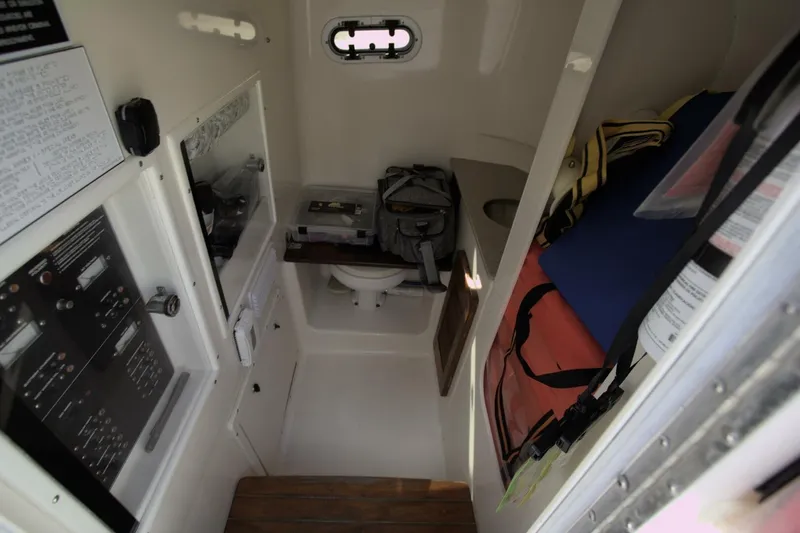 Slide: The Image of Interior of 2001 Pursuit 3070 Center Console boat with storage and control panels. - 8