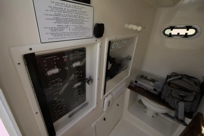 Slide: The Image of Interior of 2001 Pursuit 3070 Center Console boat with control panel and storage. - 9