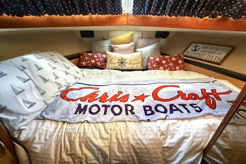 Slide: The Image of Cozy cabin interior of 1969 Chris-Craft 338 Commander with nautical-themed bedding. - 16