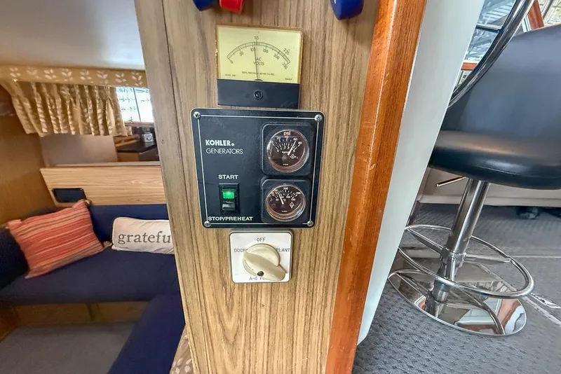 Slide: The Image of 1969 Chris-Craft 338 Commander interior with Kohler generator controls and cozy seating area. - 18