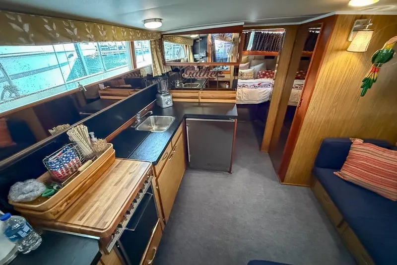 Slide: The Image of 1969 Chris-Craft 338 Commander interior with kitchen, seating, and cozy decor. - 19