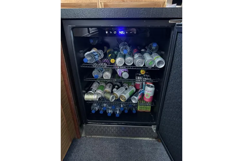 Slide: The Image of Mini fridge stocked with assorted drinks on a 1969 Chris-Craft 338 Commander. - 22