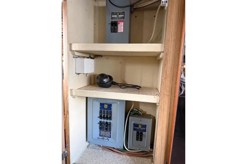 Slide: The Image of Electrical panel inside 1969 Chris-Craft 338 Commander boat, featuring circuit breakers and wiring. - 24