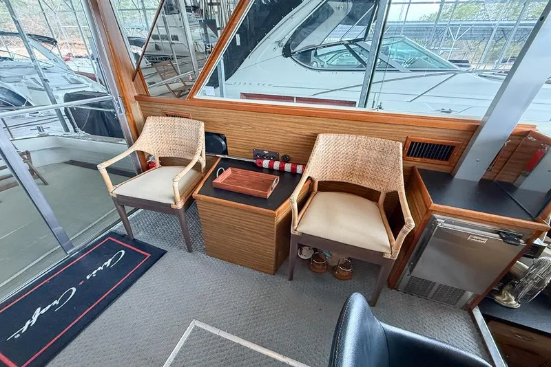 Slide: The Image of Interior of 1969 Chris-Craft 338 Commander with wicker chairs and nautical decor. - 3