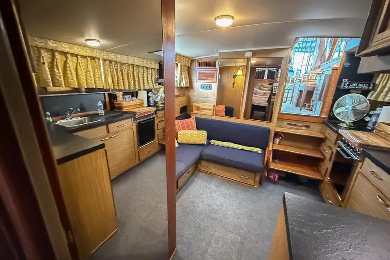 Slide: The Image of Interior of 1969 Chris-Craft 338 Commander boat with cozy seating and kitchen area. - 13