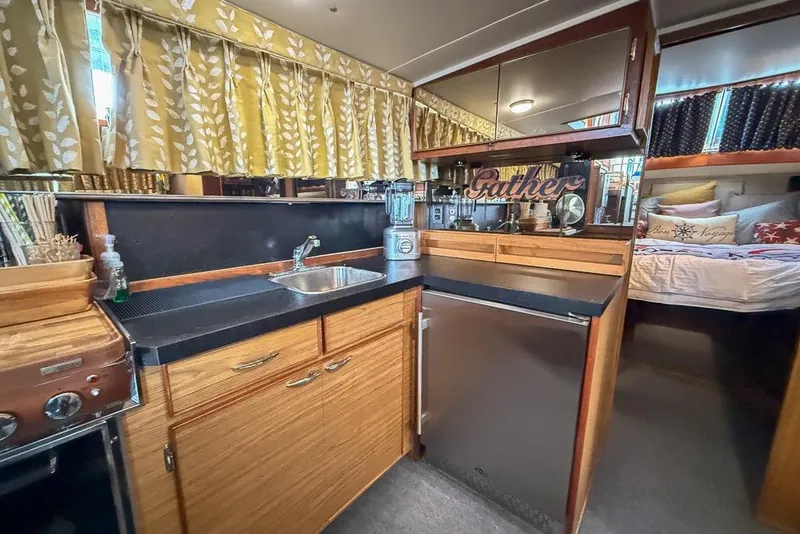 Slide: The Image of 1969 Chris-Craft 338 Commander interior with kitchen and cozy sleeping area. - 21