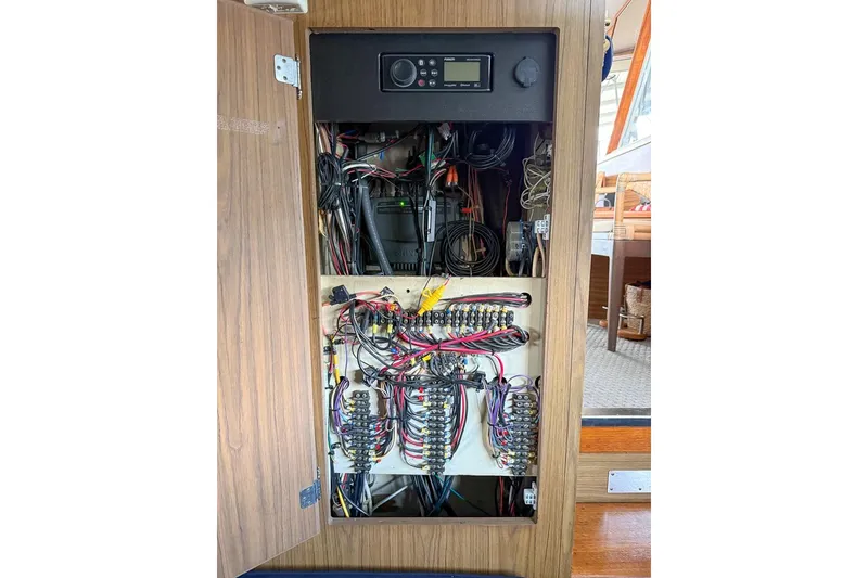 Slide: The Image of Electrical panel inside a 1969 Chris-Craft 338 Commander boat, showcasing wiring and controls. - 23