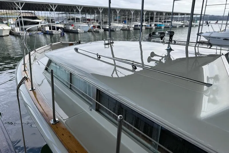 Slide: The Image of 1969 Chris-Craft 338 Commander docked at marina, showcasing sleek design and polished finish. - 27