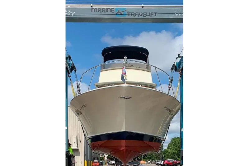 Slide: The Image of 1969 Chris-Craft 338 Commander boat in a marina lift, viewed from the front. - 29