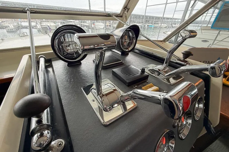 Slide: The Image of Helm controls of a 1969 Chris-Craft 338 Commander boat, featuring chrome levers and gauges. - 4