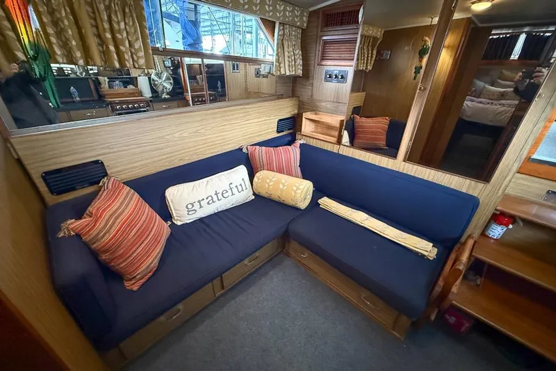 Slide: The Image of Cozy interior of 1969 Chris-Craft 338 Commander with blue seating and decorative pillows. - 9