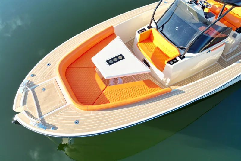 Slide: The Image of 2026 Lilybaeum Lipari 31 boat with orange seating and sleek design on calm water. - 15