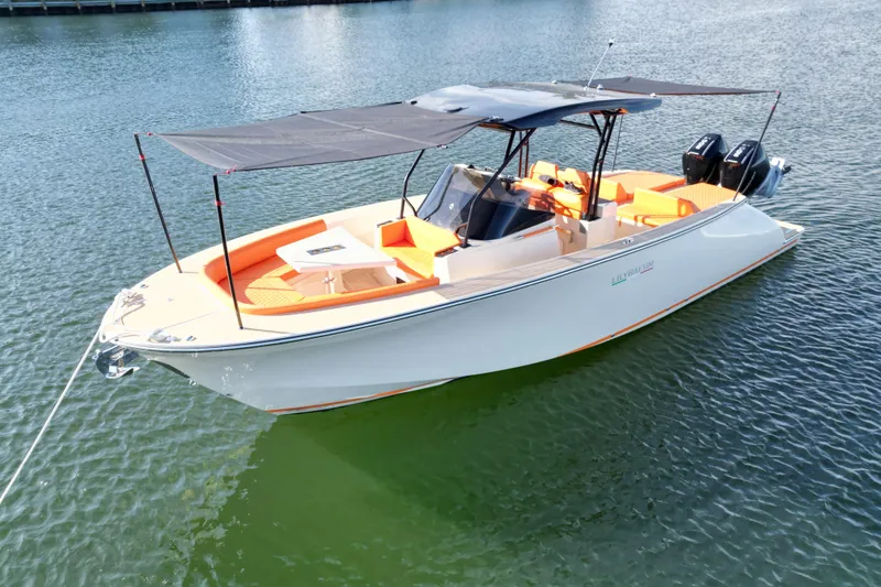 Slide: The Image of 2026 Lilybaeum Lipari 31 boat with orange seating, anchored on calm water. - 18