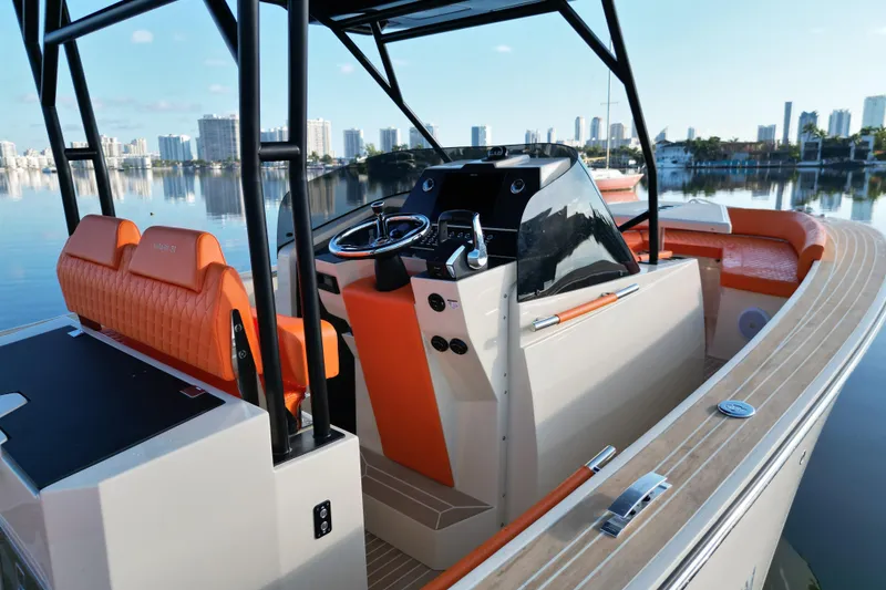 Slide: The Image of 2026 Lilybaeum Lipari 31 boat with orange seating, sleek design, and city skyline backdrop. - 22