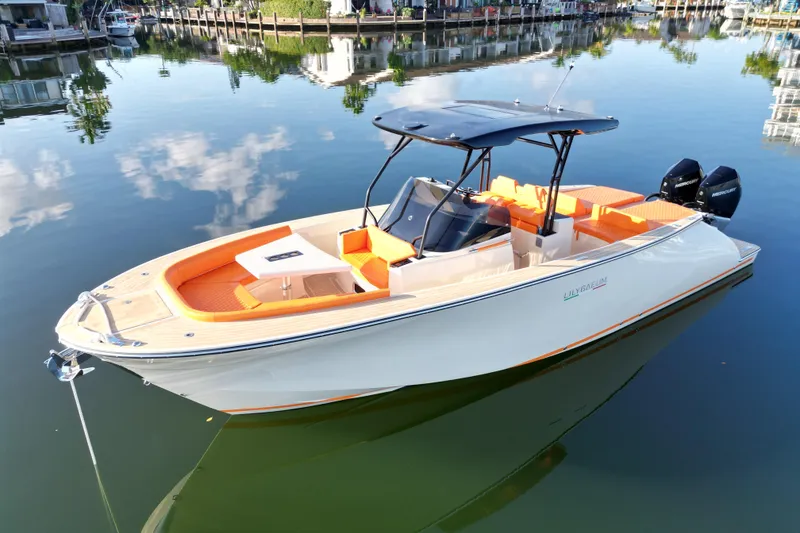 Slide: The Image of 2026 Lilybaeum Lipari 31 boat with orange seating, docked on calm water. - 5