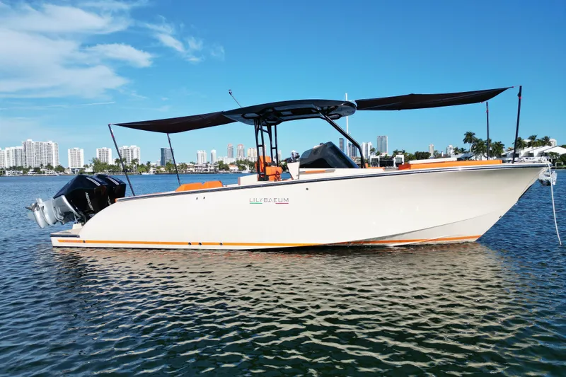 Slide: The Image of 2026 Lilybaeum Lipari 31 boat on water with city skyline background. - 9