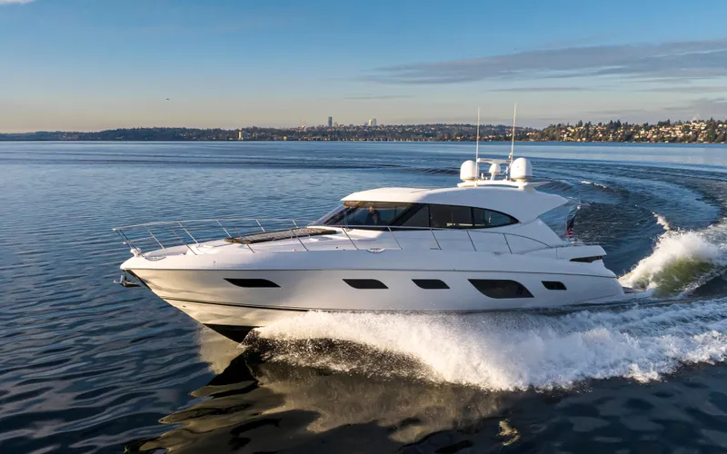 Slide: The Image of 2017 Riviera Sport Cruiser yacht gliding on calm waters under a clear sky. - 13