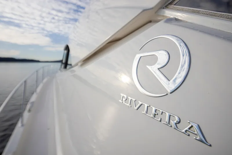 Slide: The Image of 2017 Riviera Sport Cruiser boat with logo, side view on calm water. - 36