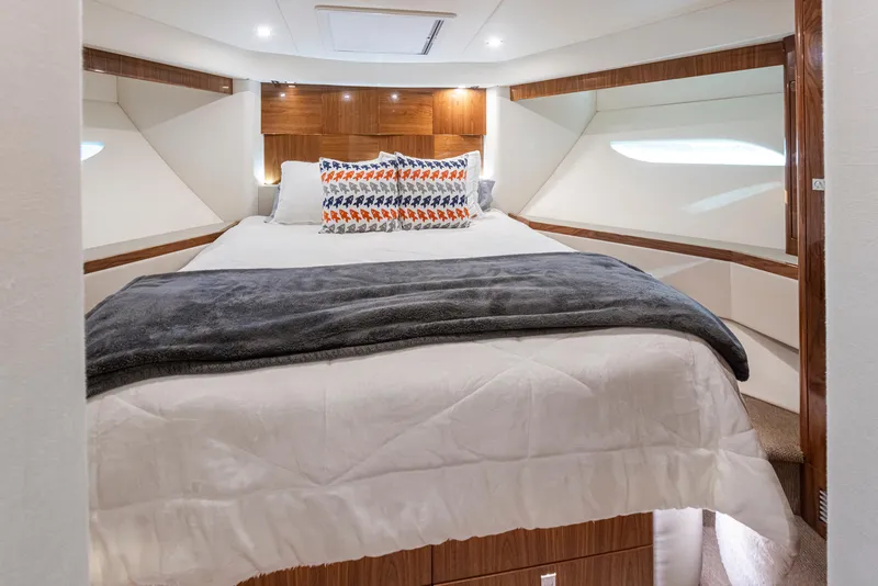Slide: The Image of 2017 Riviera Sport Cruiser bedroom with cozy bed, modern design, and ambient lighting. - 44