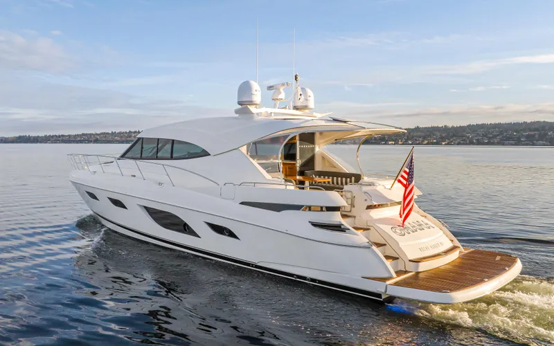 The Image of 2017 Riviera Sport Cruiser yacht on calm water, rear view with American flag. - 0