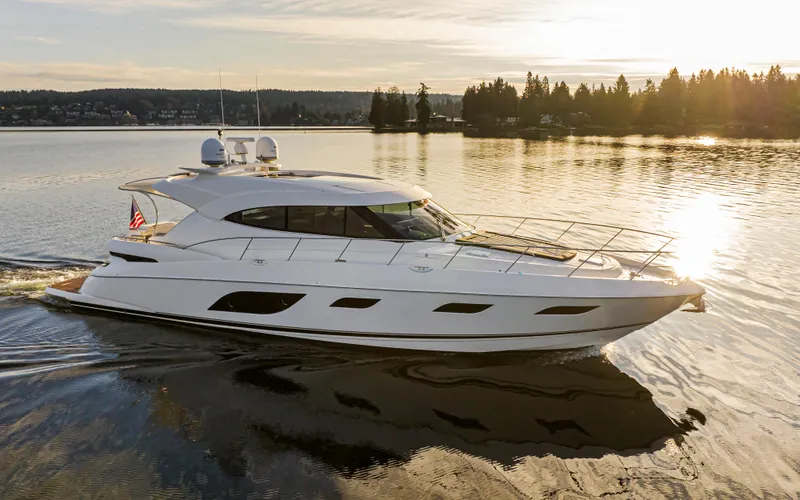 Slide: The Image of 2017 Riviera Sport Cruiser yacht on serene lake at sunset. - 10