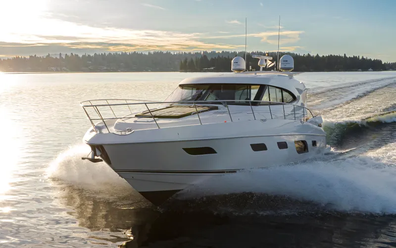 Slide: The Image of 2017 Riviera Sport Cruiser yacht speeding on a serene lake at sunset. - 12