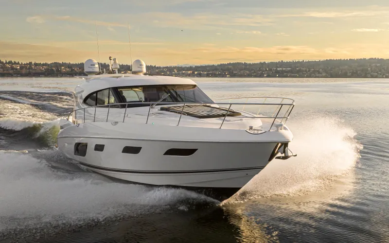 Slide: The Image of 2017 Riviera Sport Cruiser speeding on a serene lake at sunset. - 14