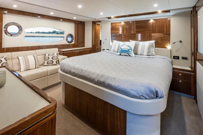 Slide: The Image of Luxurious interior of 2017 Riviera Sport Cruiser with elegant wood finishes and plush bedding. - 20