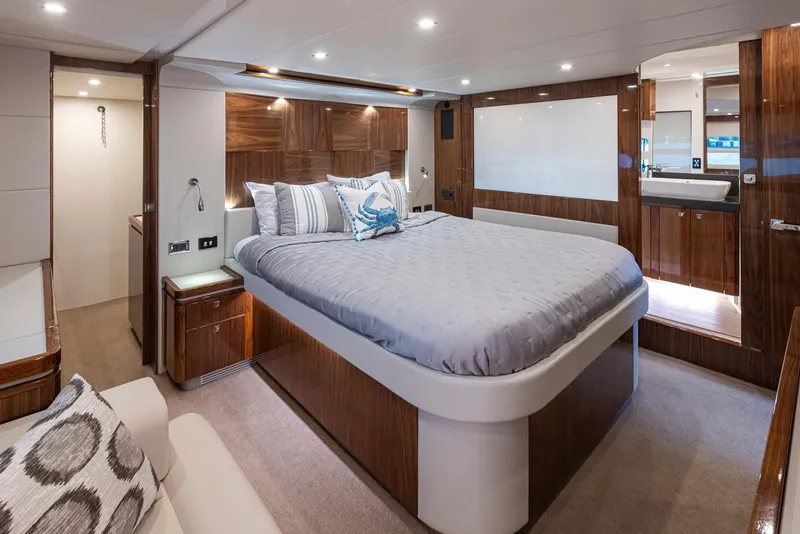 Slide: The Image of Luxurious 2017 Riviera Sport Cruiser bedroom with elegant wood finishes and modern lighting. - 21