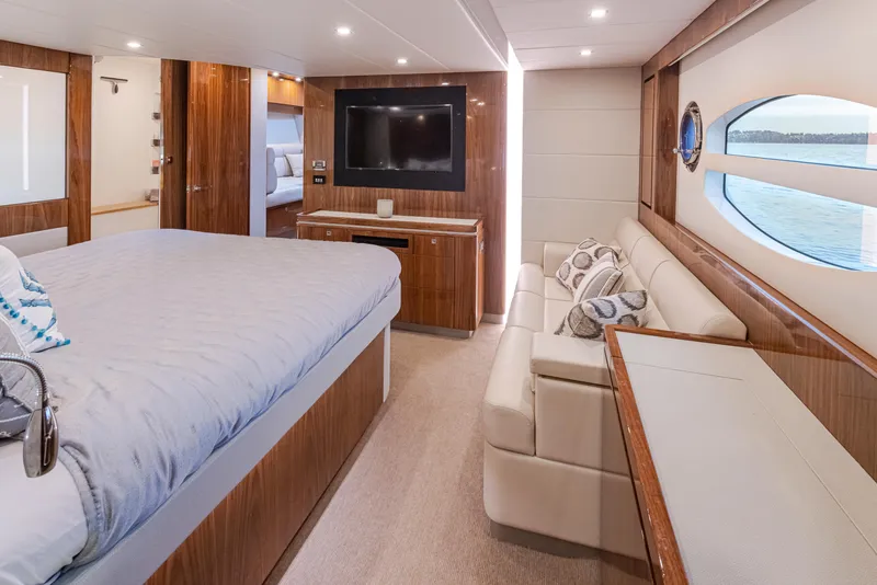 Slide: The Image of Luxurious interior of 2017 Riviera Sport Cruiser yacht with bed, sofa, and TV. - 22