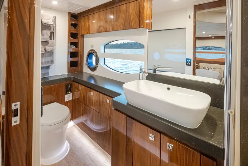 Slide: The Image of Luxurious bathroom interior of 2017 Riviera Sport Cruiser yacht with modern fixtures and wood finish. - 23