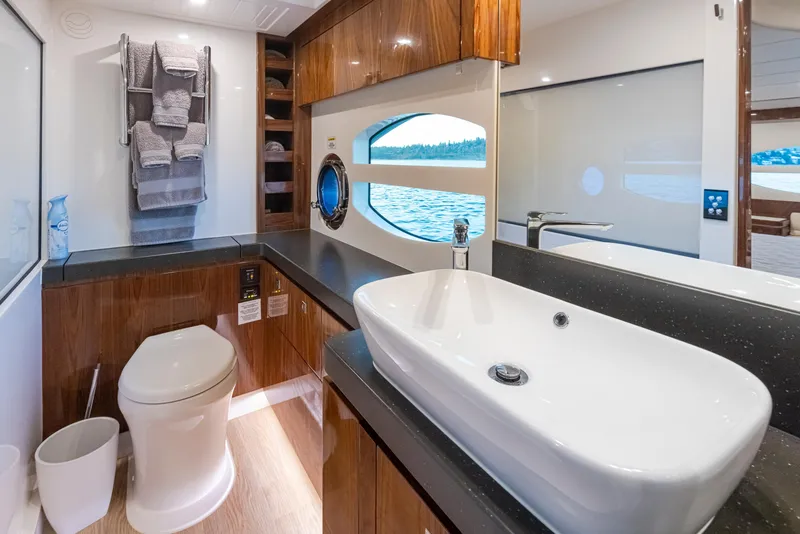 Slide: The Image of Luxurious bathroom in 2017 Riviera Sport Cruiser yacht with modern fixtures and ocean view. - 24