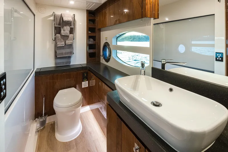 Slide: The Image of Luxurious 2017 Riviera Sport Cruiser bathroom with modern fixtures and elegant wood accents. - 26