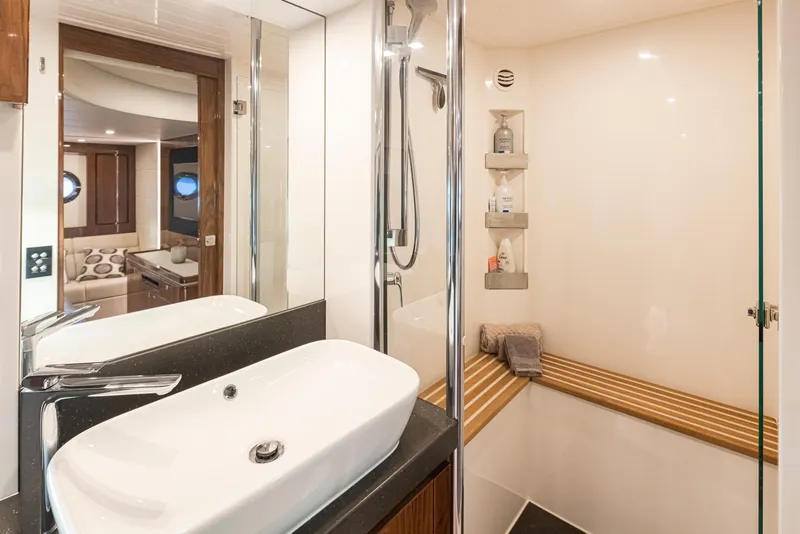 Slide: The Image of Luxurious bathroom in 2017 Riviera Sport Cruiser yacht with modern fixtures and elegant design. - 28