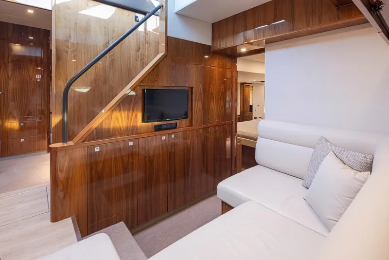 Slide: The Image of Interior of 2017 Riviera Sport Cruiser with modern wood paneling and white seating. - 29