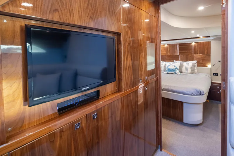 Slide: The Image of Luxurious 2017 Riviera Sport Cruiser interior with wood paneling, TV, and cozy bedroom. - 30