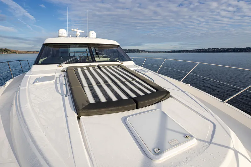 Slide: The Image of 2017 Riviera Sport Cruiser yacht on calm water, featuring a spacious deck and sleek design. - 37