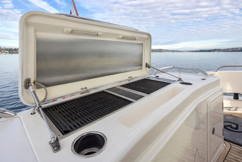 Slide: The Image of 2017 Riviera Sport Cruiser outdoor grill on deck with scenic water view. - 38