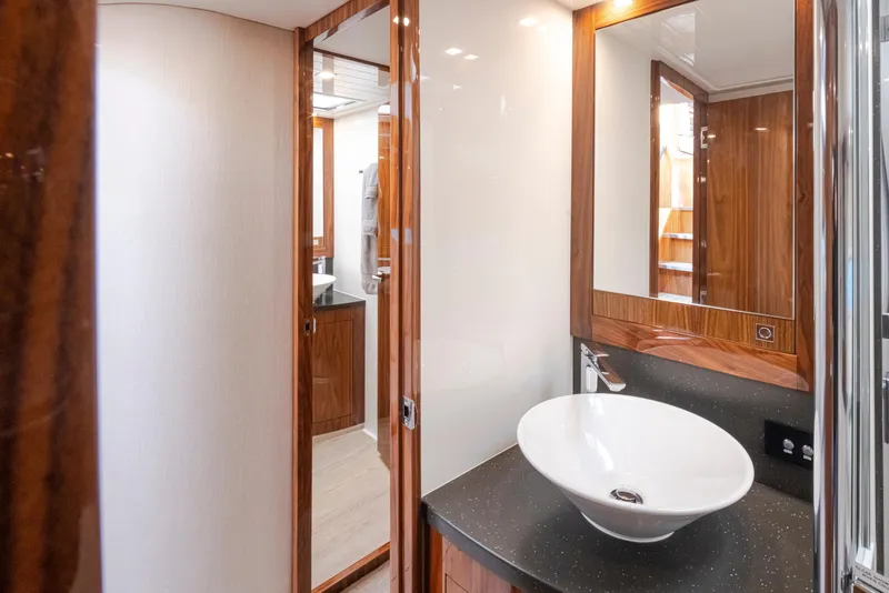 Slide: The Image of 2017 Riviera Sport Cruiser bathroom with modern sink and wooden accents. - 42