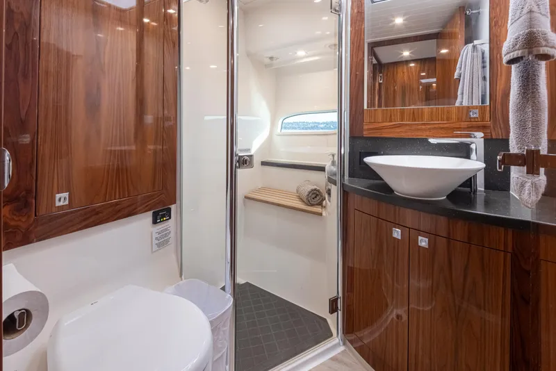 Slide: The Image of Luxurious bathroom in 2017 Riviera Sport Cruiser with wood accents and modern fixtures. - 43