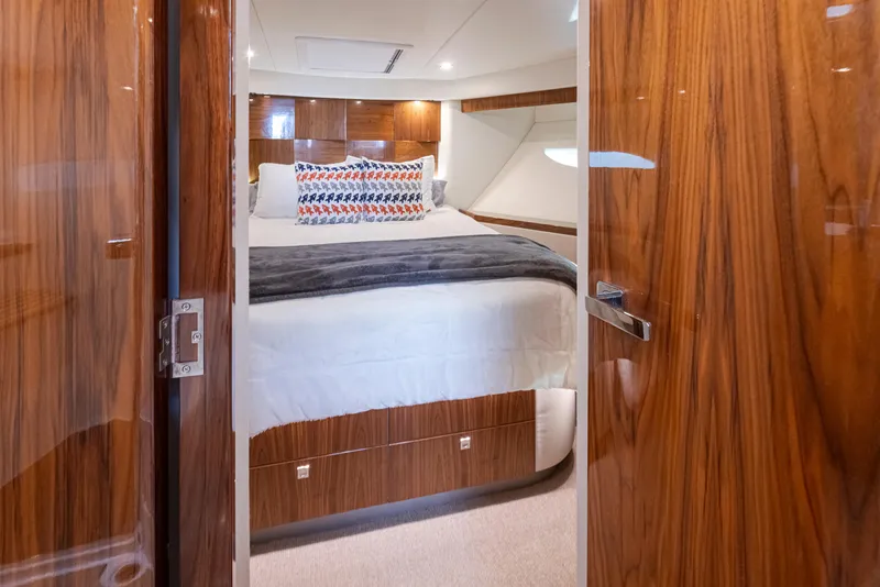 Slide: The Image of Luxurious 2017 Riviera Sport Cruiser cabin with elegant wood finish and cozy bedding. - 45